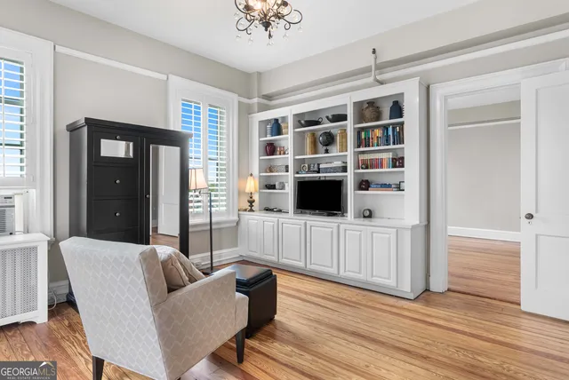 a living room with furniture and wooden floor