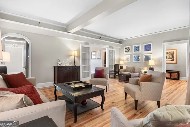 a living room with furniture a rug and a window