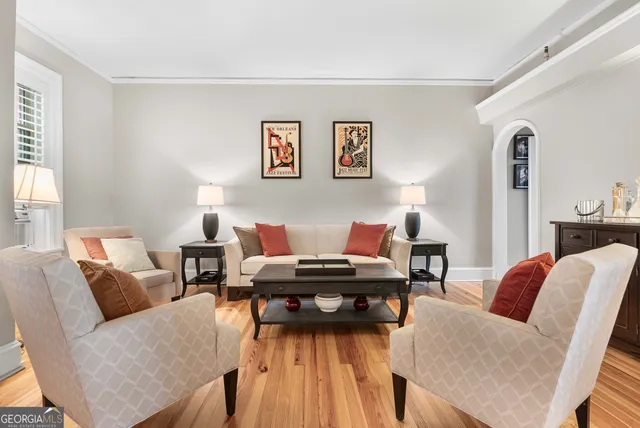 a living room with furniture and wooden floor