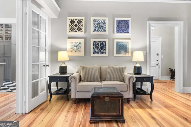 a living room with furniture and wooden floor