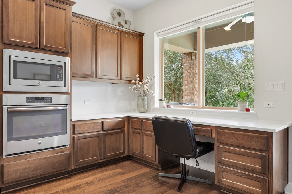 558 Merion Drive Austin, TX 78737 - Photo 15 of 40 a kitchen with a stove a sink and a microwave