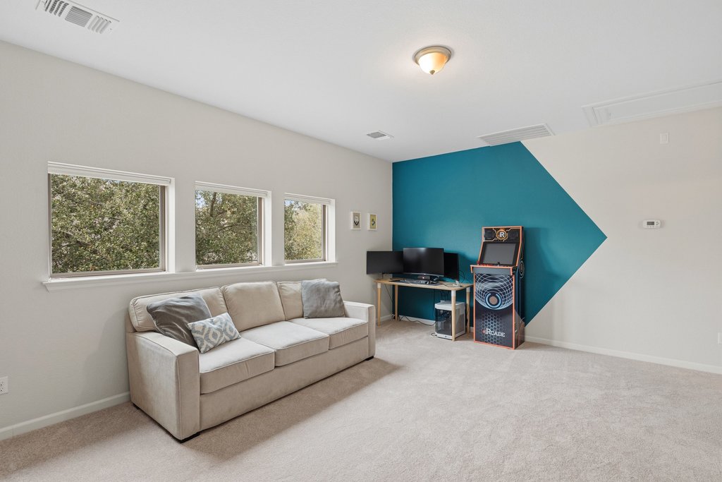 558 Merion Drive Austin, TX 78737 - Photo 24 of 40 a living room with furniture and a flat screen tv