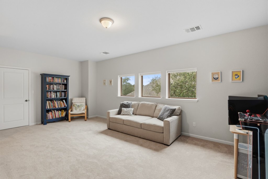 558 Merion Drive Austin, TX 78737 - Photo 25 of 40 a living room with furniture and a flat screen tv