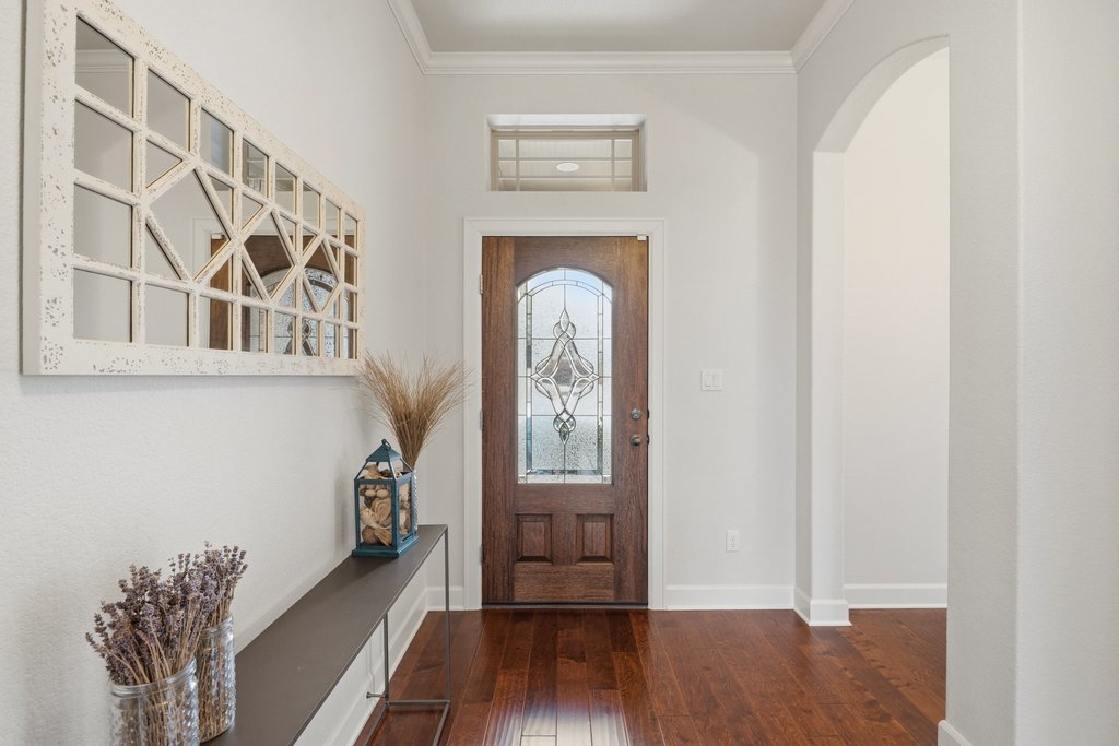 558 Merion Drive Austin, TX 78737 - Photo 3 of 40 a view of a hallway with wooden floor and entryway