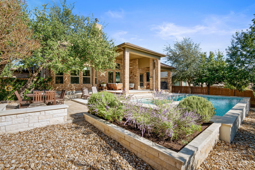 558 Merion Drive Austin, TX 78737 - Photo 36 of 40 a front view of a house with garden