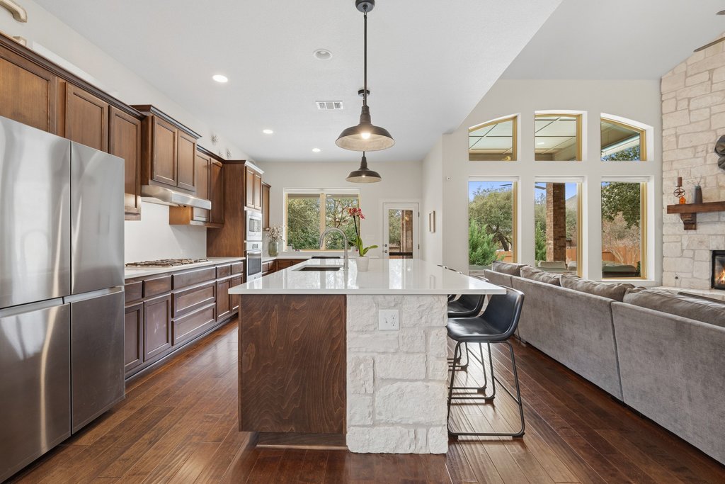 558 Merion Drive Austin, TX 78737 - Photo 10 of 40 a kitchen with stainless steel appliances granite countertop a stove and refrigerator