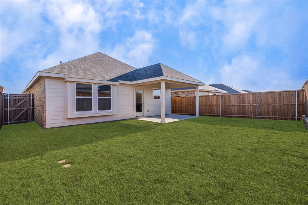 1947 Long Pond Trail Forney, TX 75126 - Photo 12 of 17 Back of property with a patio area, a shingled roof, a fenced backyard, and a gate