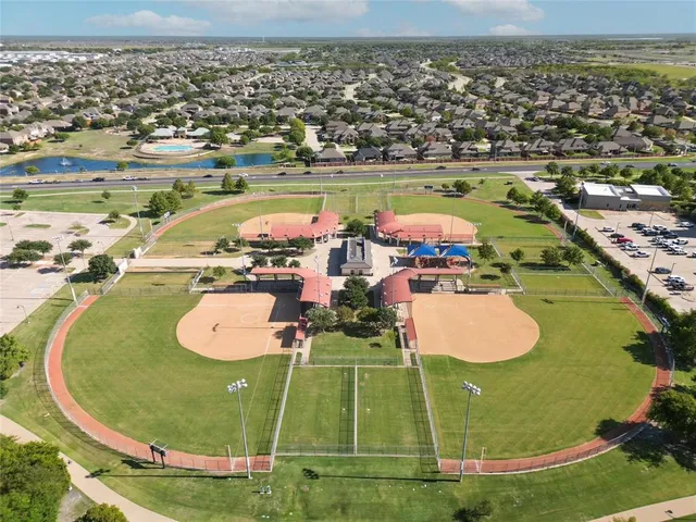 an aerial view of a pool a playground patio swimming pool and outdoor seating