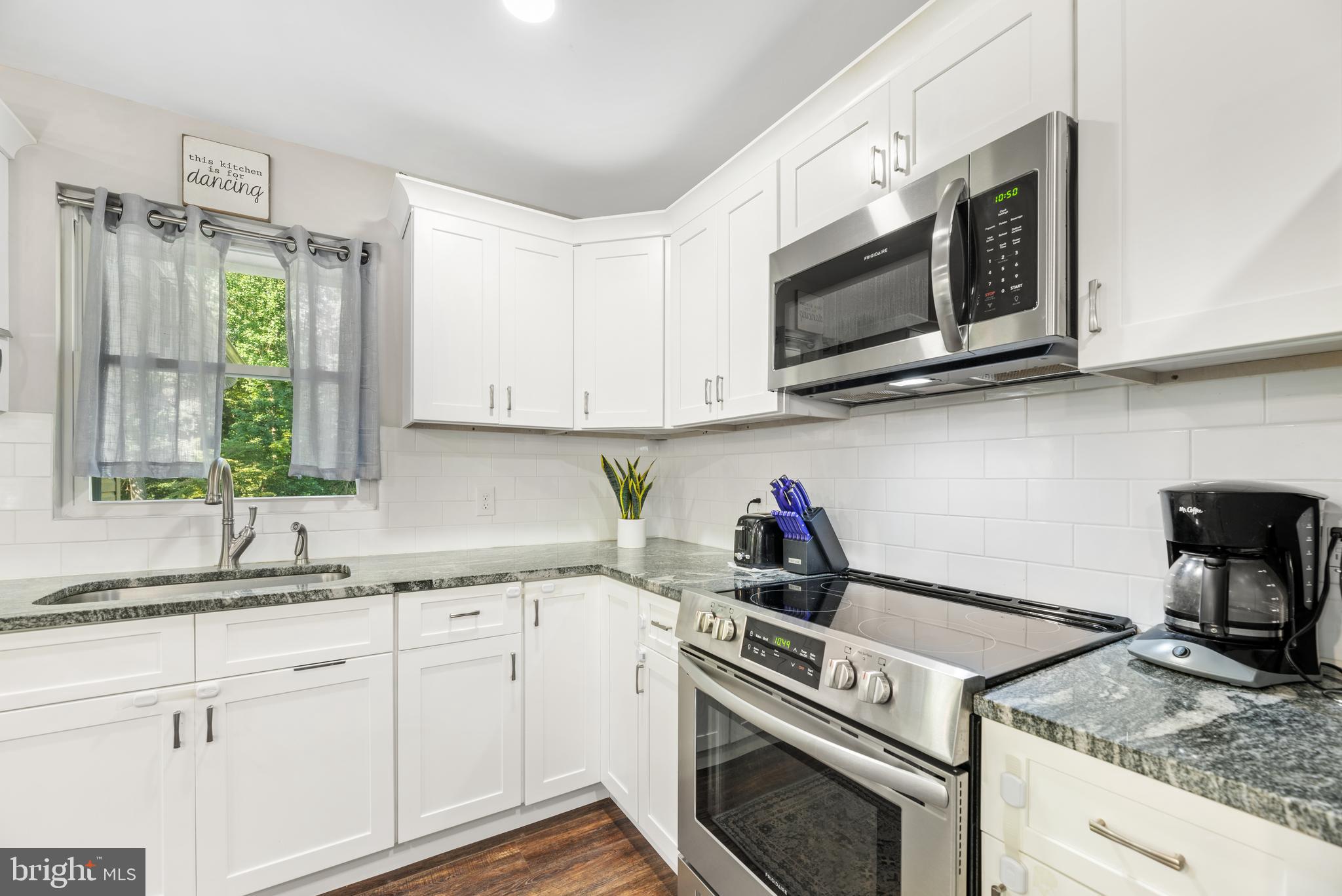 5756 Stephen Reid Road Huntingtown, MD 20639 - Photo 24 of 42 a kitchen with granite countertop a sink cabinets and window