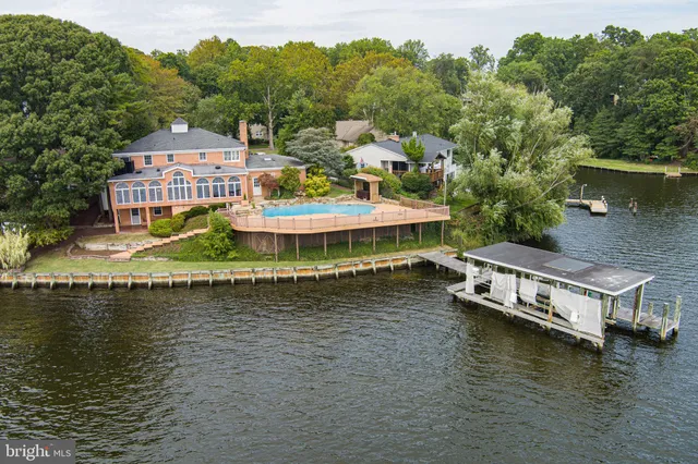 a view of a lake with a large house in the background