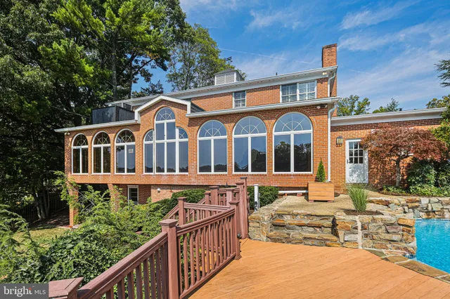 an aerial view of a house with a yard lake table and chairs