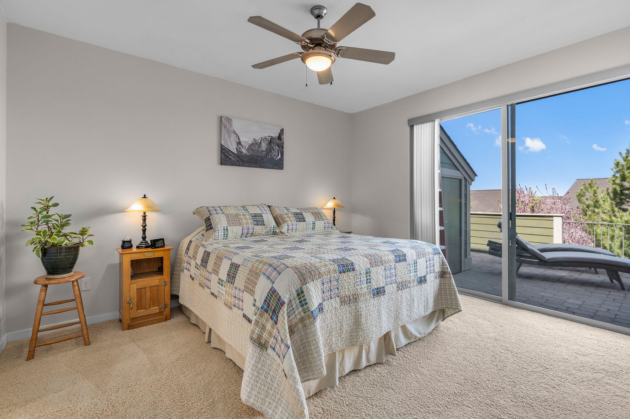 10870 Village Loop Redmond, OR 97756 - Photo 11 of 35 a bedroom with a bed and a chandelier