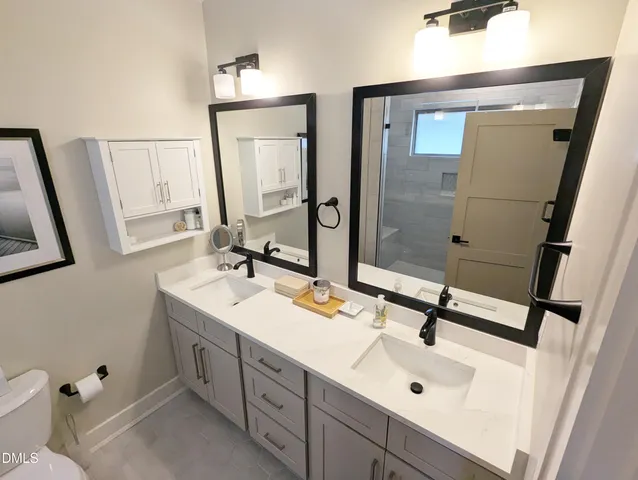 a bathroom with a sink a toilet and mirror