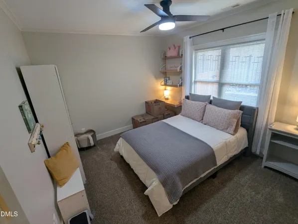 a bedroom with a bed and window