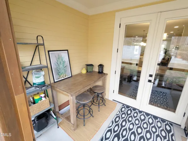 a view of a workspace with furniture and wooden floor