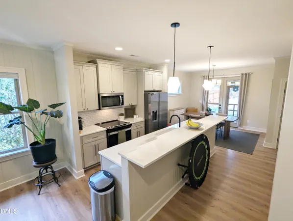a kitchen with sink cabinets and wooden floor