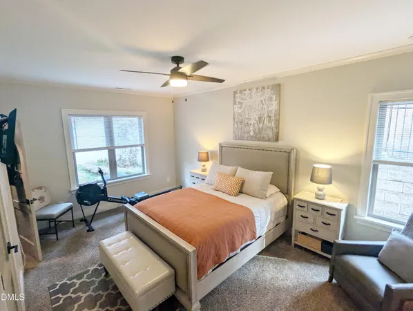 a bedroom with a bed a couch and window