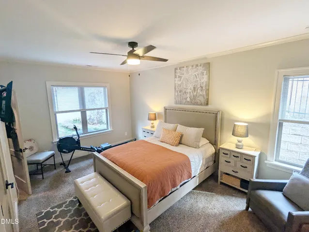 a bedroom with a bed a couch and window