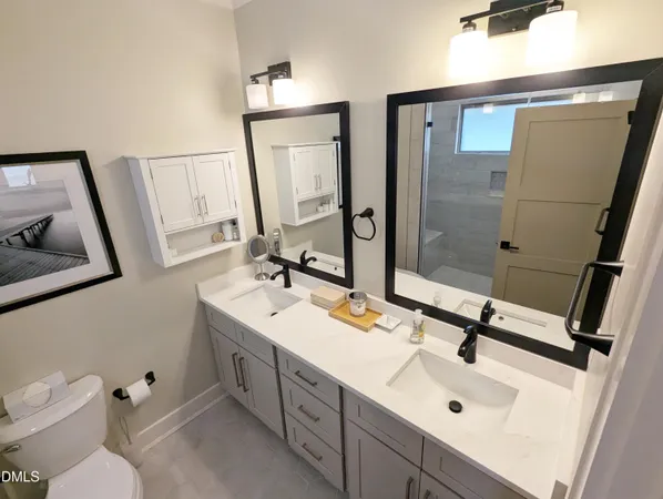 a bathroom with a sink toilet and mirror