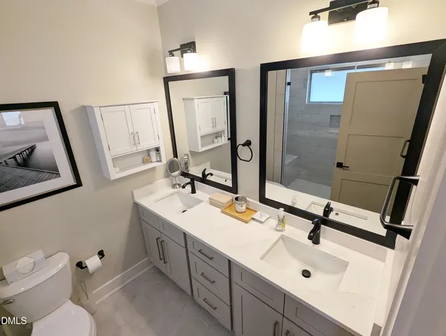 a bathroom with a sink toilet and mirror