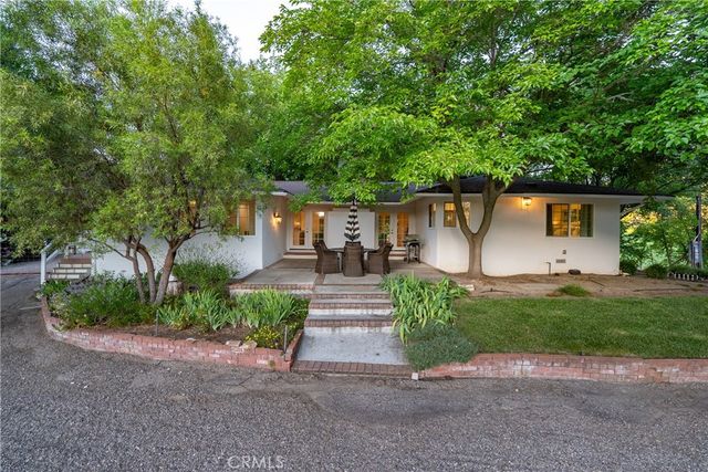 a view of backyard with swimming pool and outdoor seating