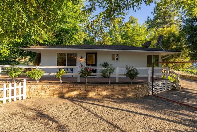 a view of a lush green hillside and a houses
