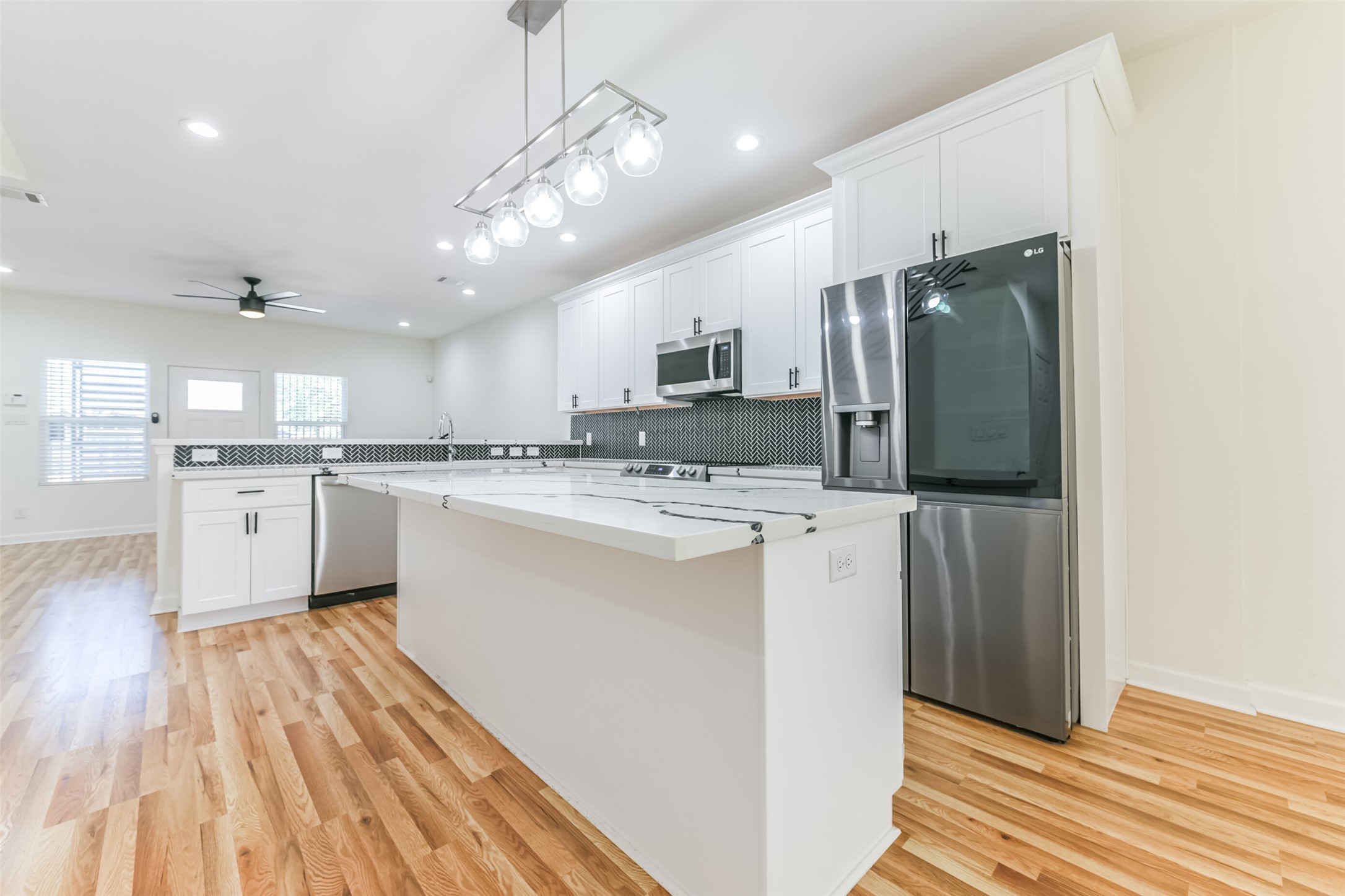 4830 Burma Road, Unit A B Houston, TX 77033 - Photo 13 of 34 a kitchen with kitchen island a sink stainless steel appliances and cabinets