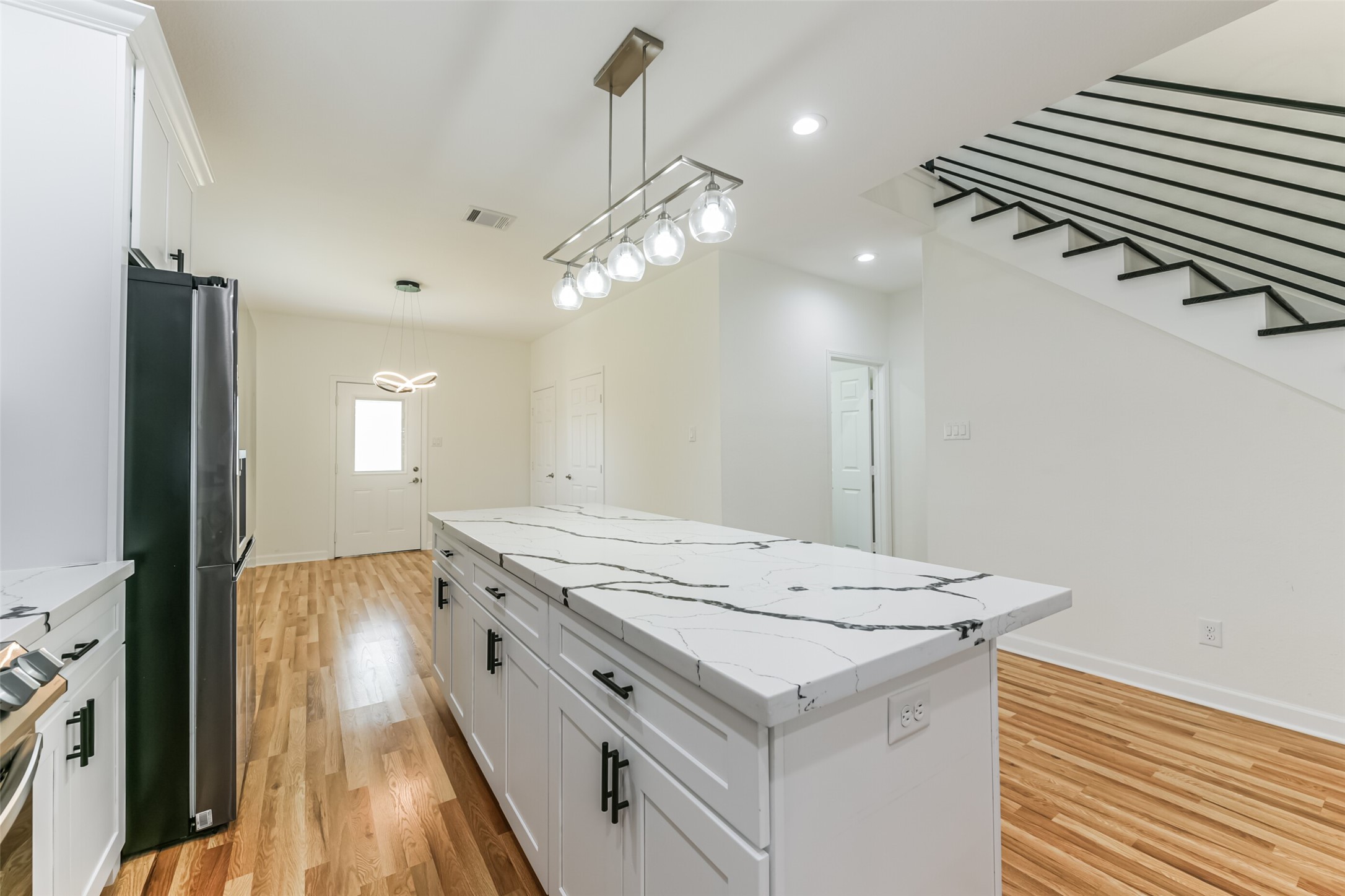 4830 Burma Road, Unit A B Houston, TX 77033 - Photo 15 of 34 a kitchen with a stove a sink and a refrigerator