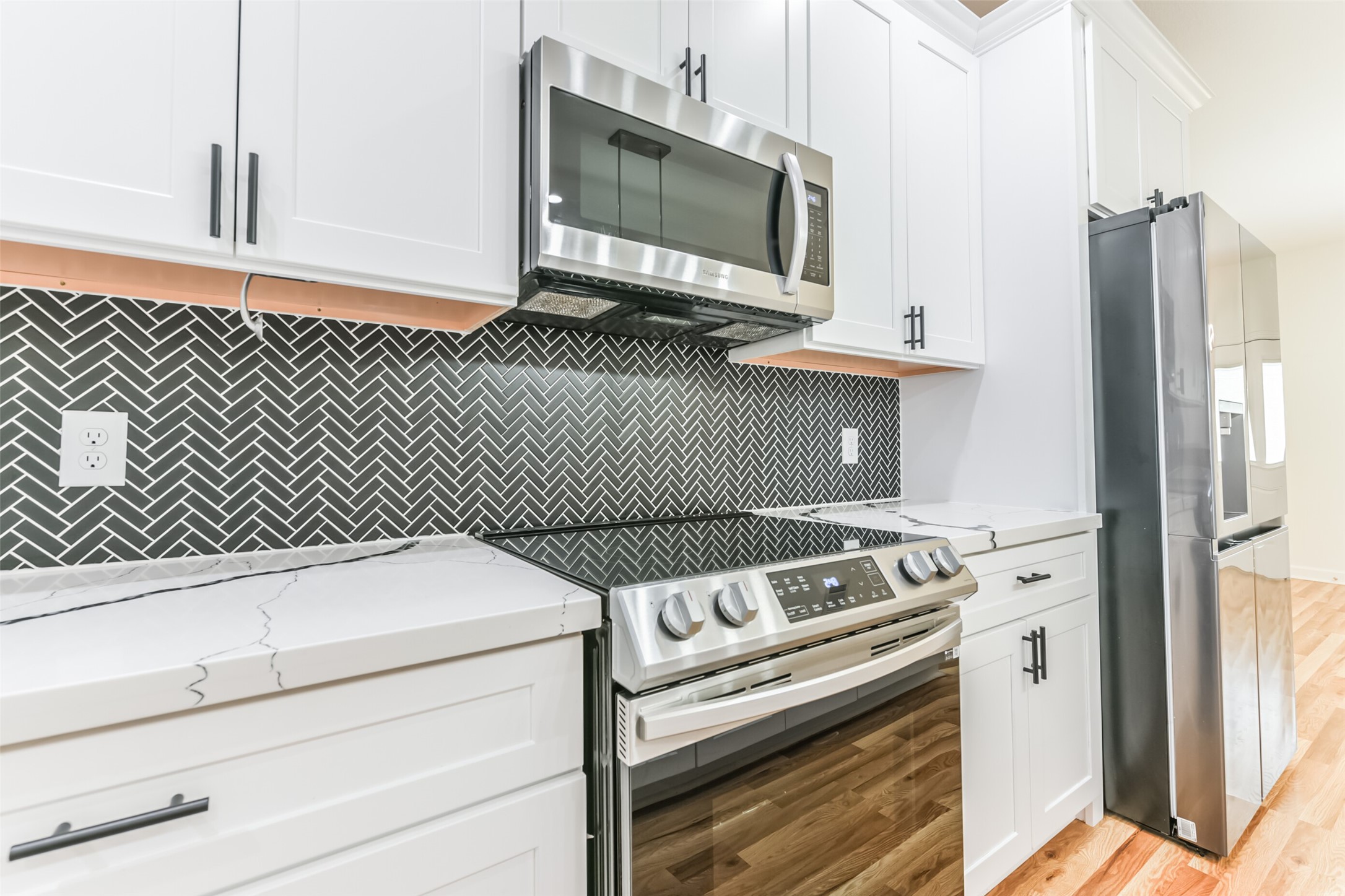 4830 Burma Road, Unit A B Houston, TX 77033 - Photo 17 of 34 a kitchen with a stove and a microwave