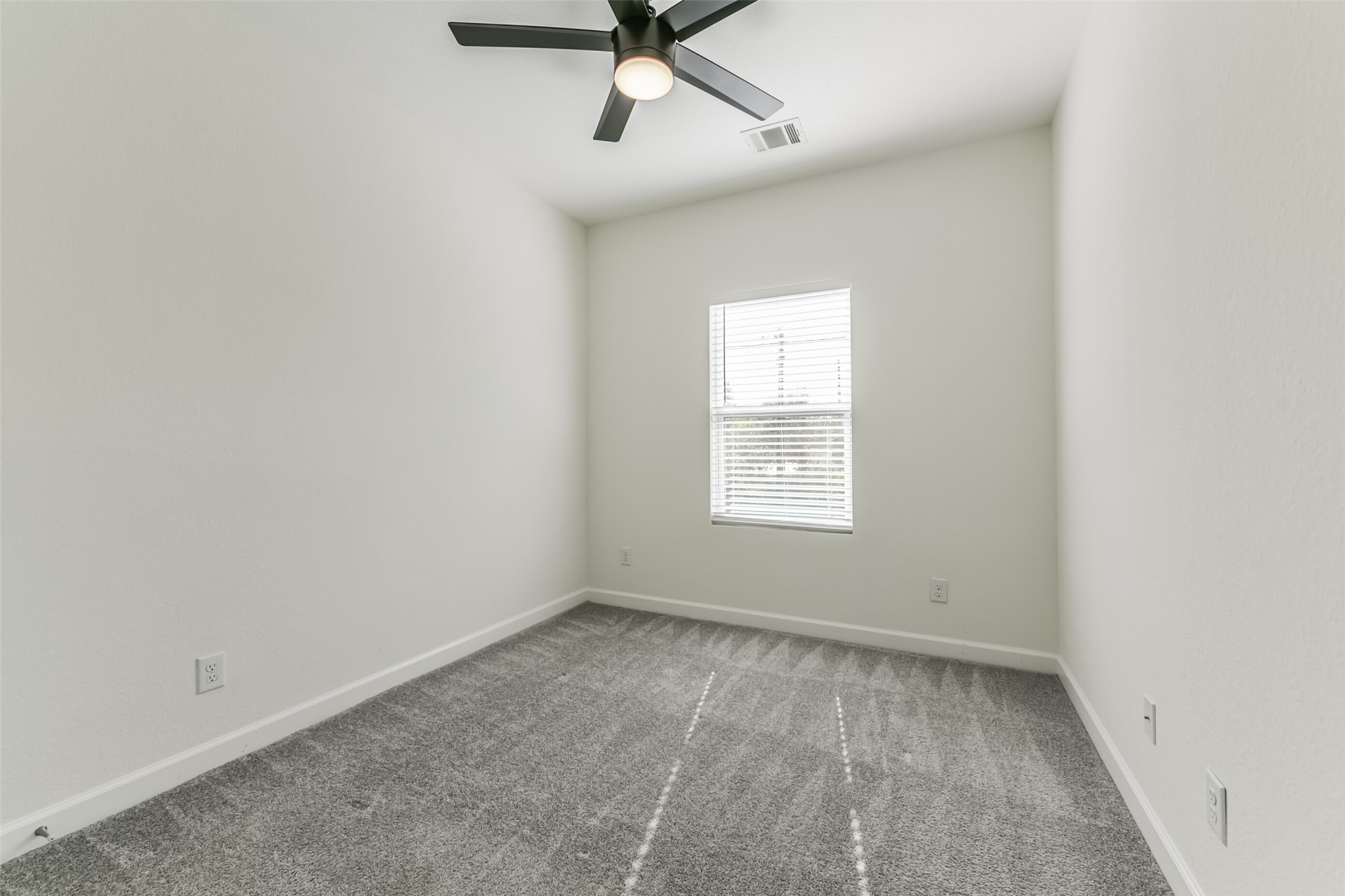 4830 Burma Road, Unit A B Houston, TX 77033 - Photo 22 of 34 an empty room with a window and a fan