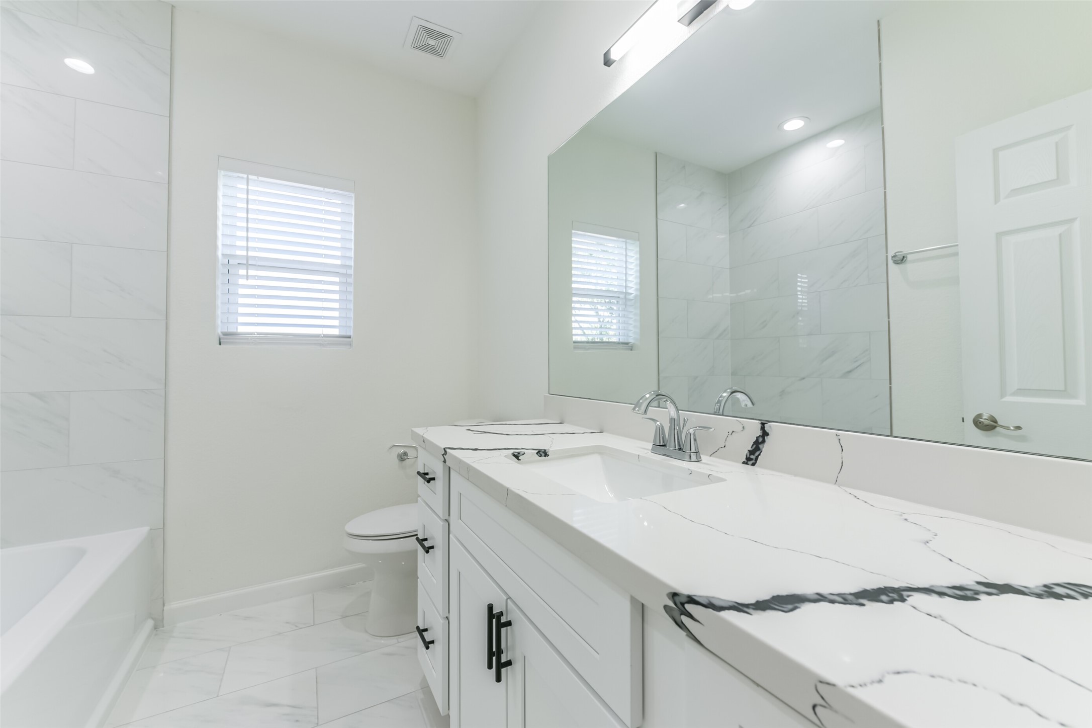4830 Burma Road, Unit A B Houston, TX 77033 - Photo 24 of 34 a bathroom with a sink a toilet and mirror