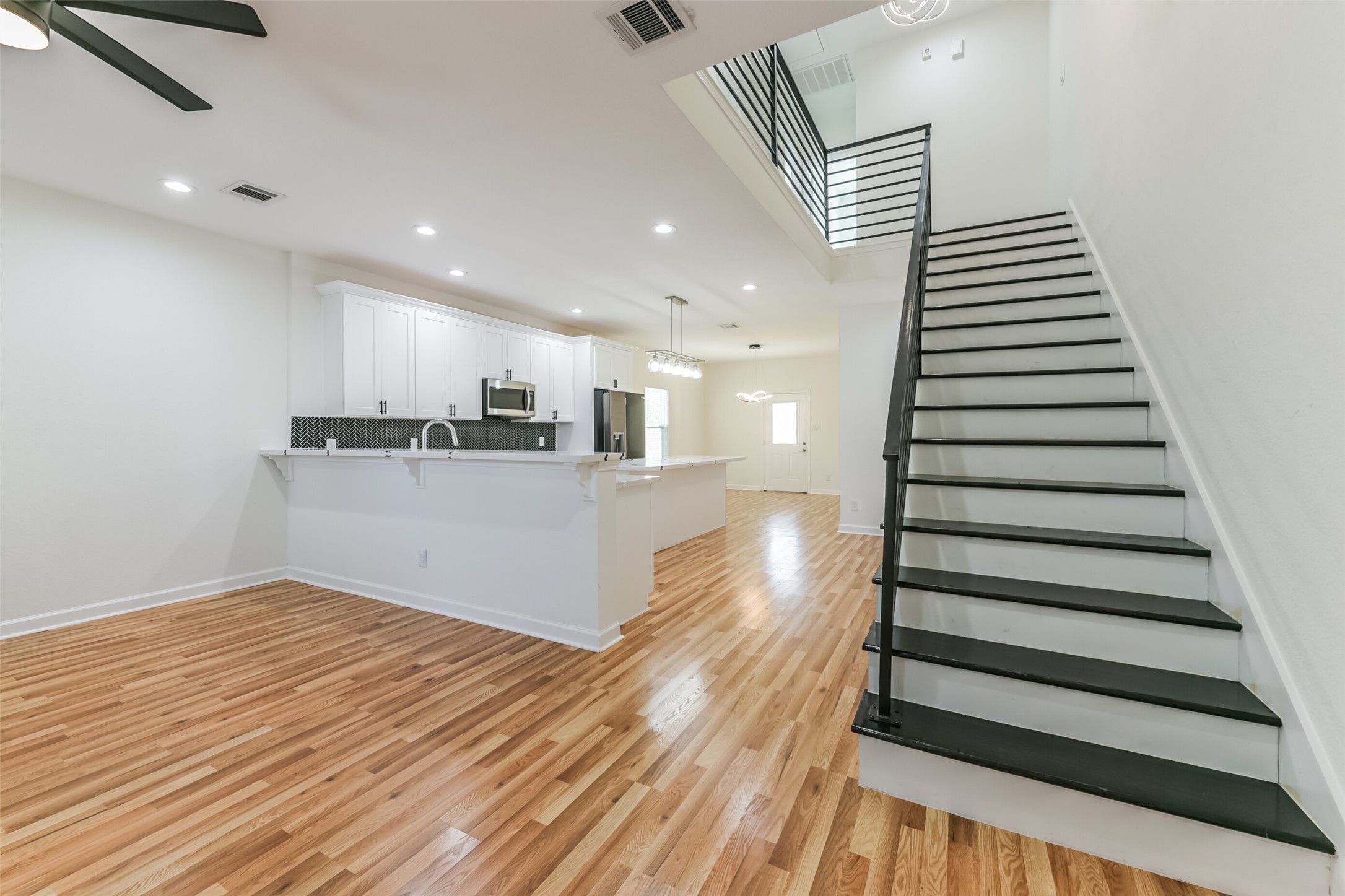 4830 Burma Road, Unit A B Houston, TX 77033 - Photo 5 of 34 a view of a kitchen with wooden floor and stairs