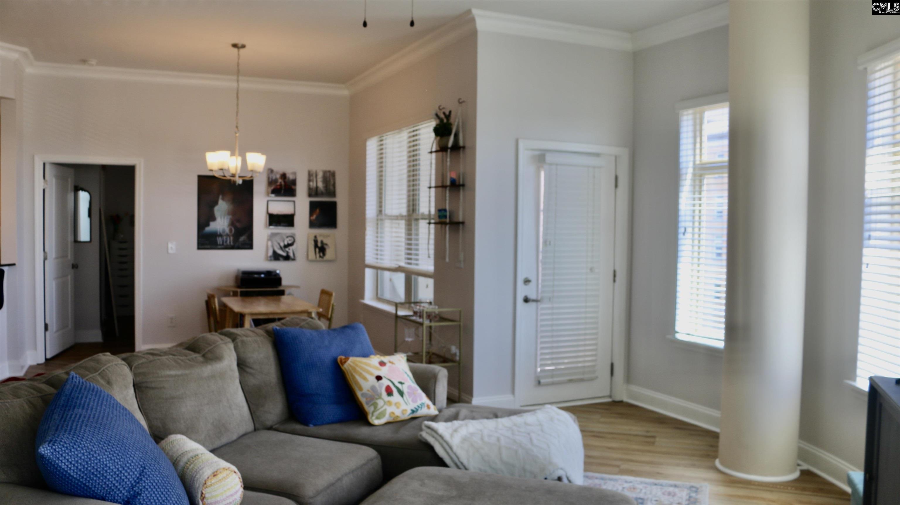 601 Main Street, Unit 323 Columbia, SC 29201 - Photo 25 of 68 a living room with furniture and a chandelier