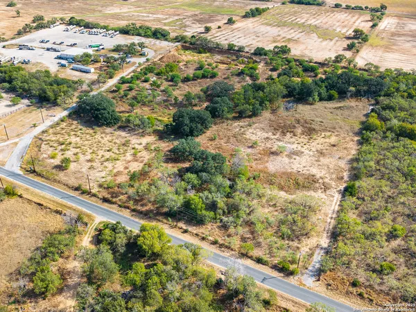 a view of a yard with wooden fence