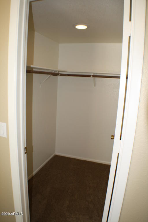 4745 East St John Road Phoenix, AZ 85032 - Photo 11 of 20 a view of walk in closet with empty racks