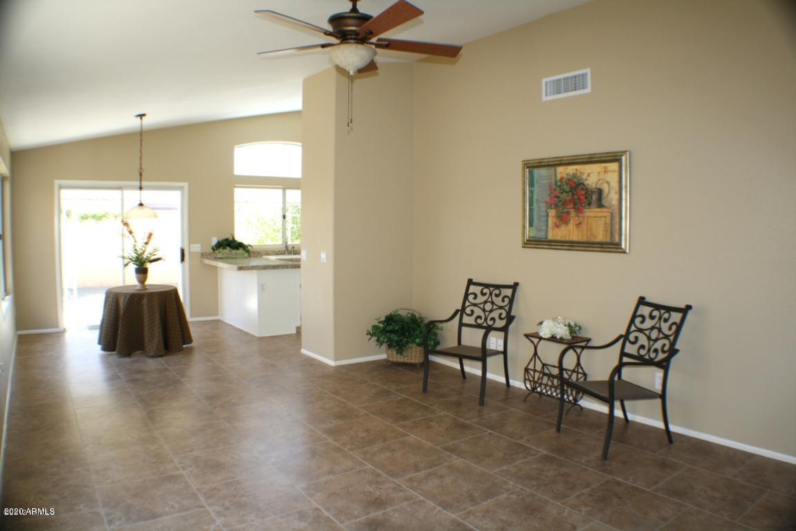 4745 East St John Road Phoenix, AZ 85032 - Photo 15 of 20 a living room with furniture and a chandelier