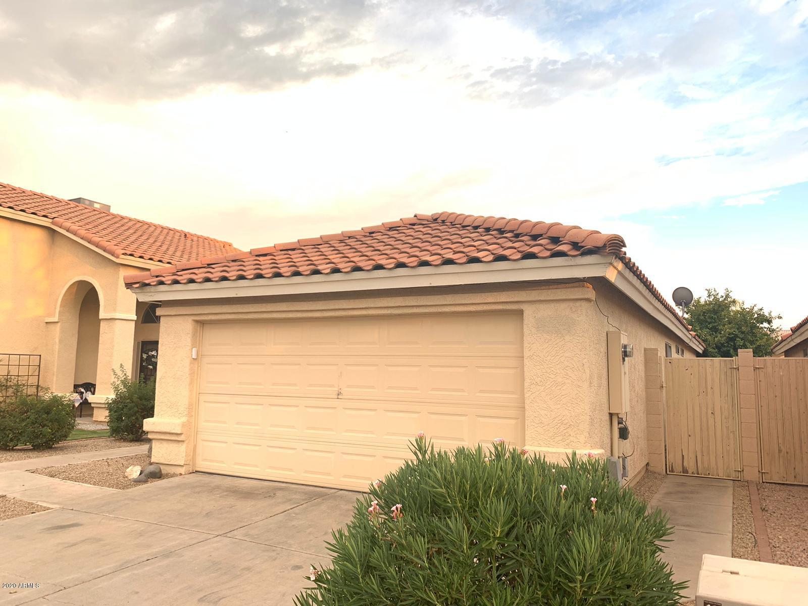 4745 East St John Road Phoenix, AZ 85032 - Photo 3 of 20 a view of a house with a yard and potted plants