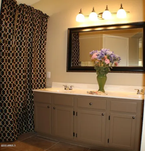 a bathroom with a sink mirror and vanity