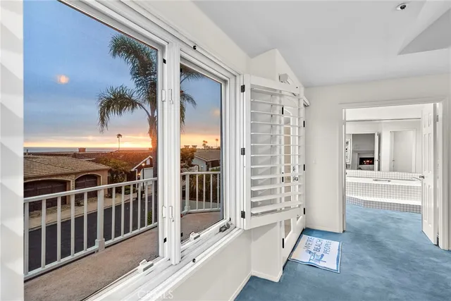 a large bedroom with a large bed and chandelier