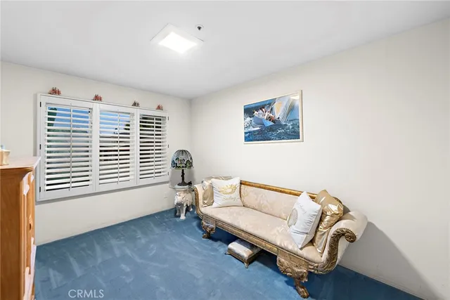 a bedroom with bed and a large window