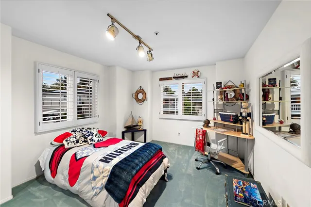 a bedroom with a bed window and couch