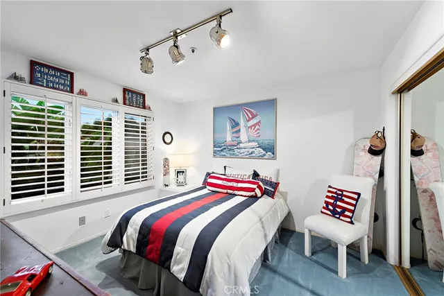 a bathroom with a sink mirror vanity and toilet