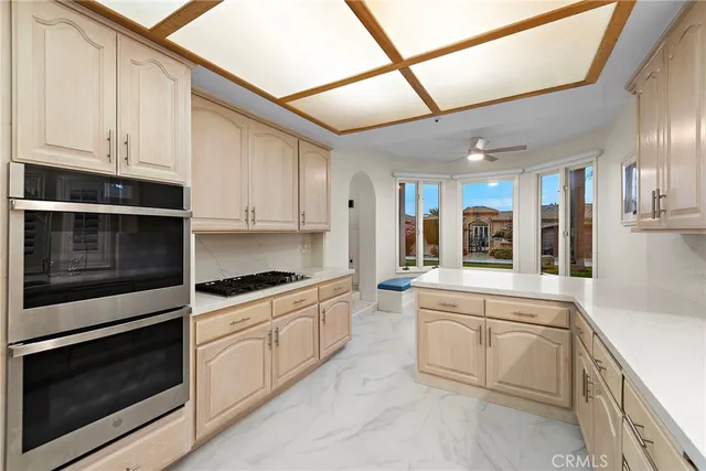 a kitchen with white cabinets and appliances