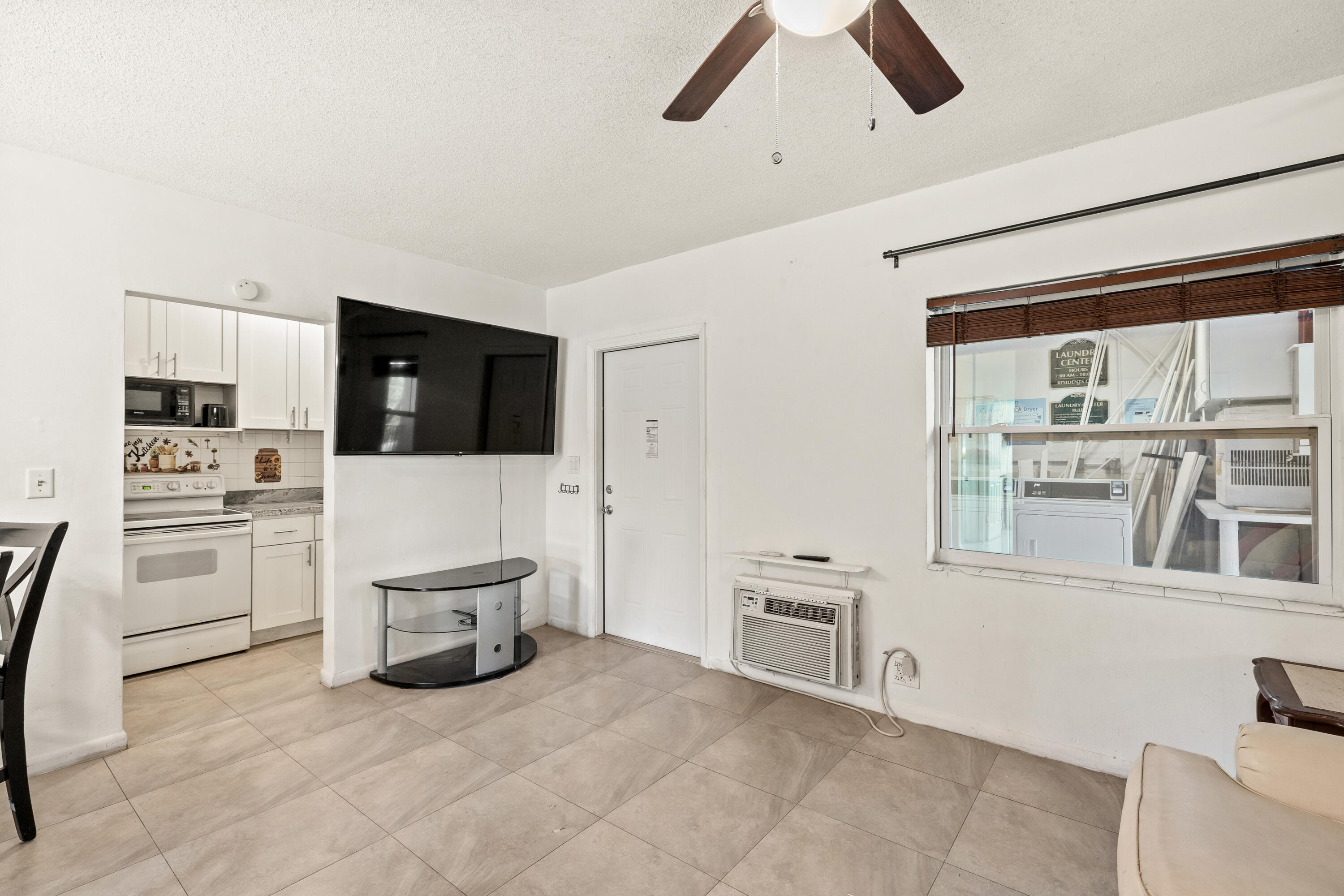 1021 Northeast 24th Avenue, Unit 12 Pompano Beach, FL 33062 - Photo 14 of 33 a living room with furniture and a flat screen tv