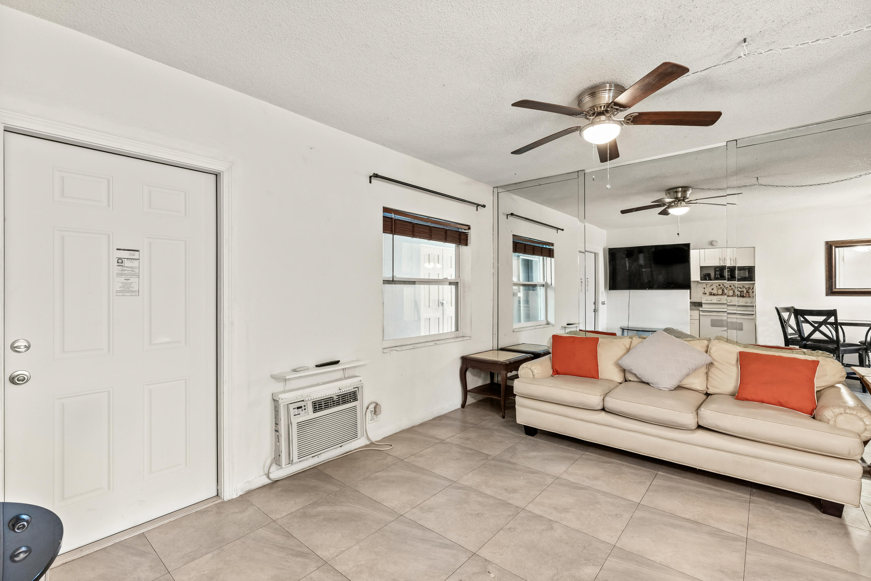 1021 Northeast 24th Avenue, Unit 12 Pompano Beach, FL 33062 - Photo 15 of 33 a living room with furniture and a flat screen tv