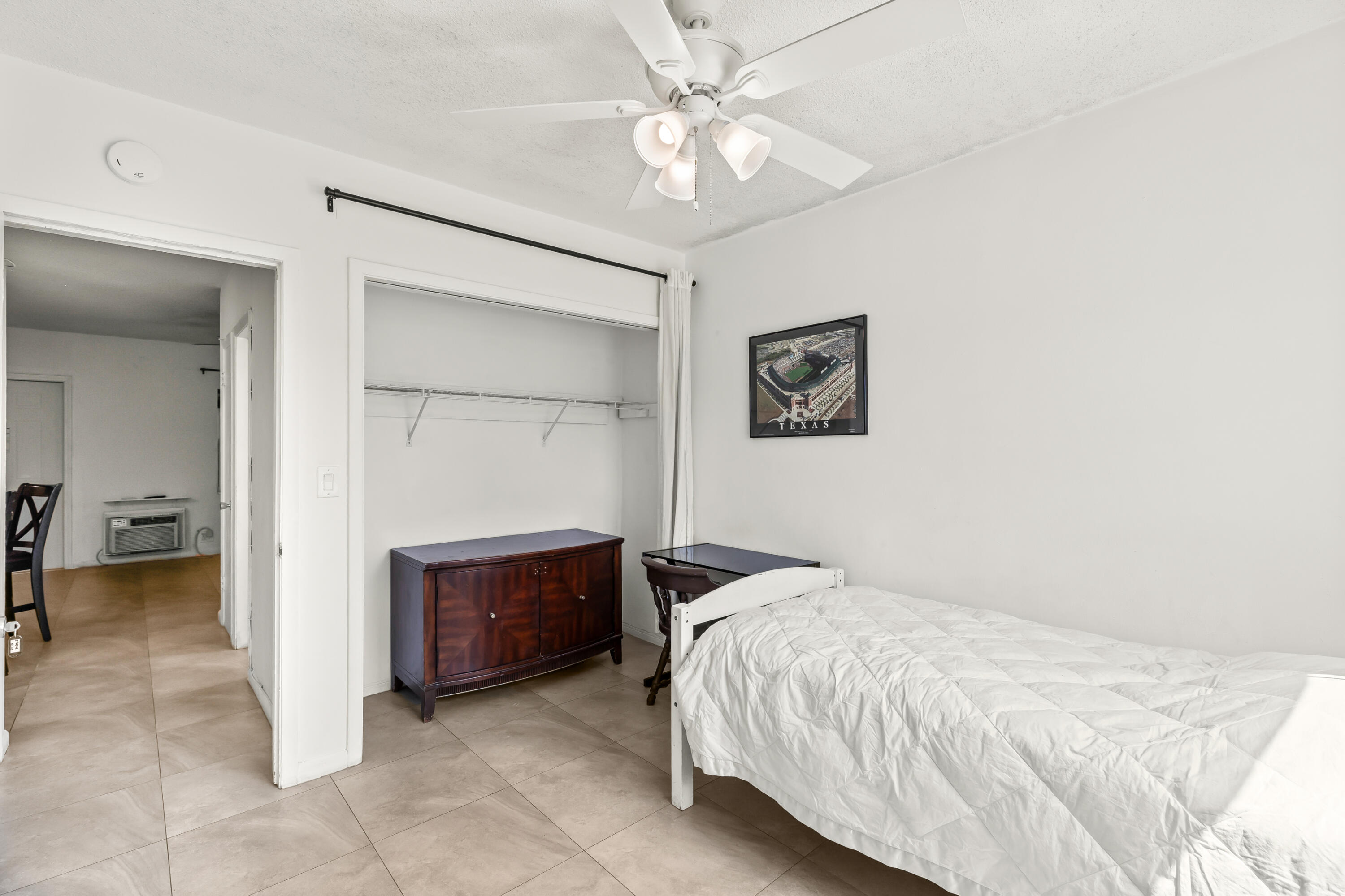 1021 Northeast 24th Avenue, Unit 12 Pompano Beach, FL 33062 - Photo 21 of 33 a bedroom with a bed and a chandelier