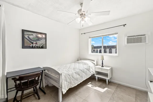 a bedroom with a bed and a lamp on table