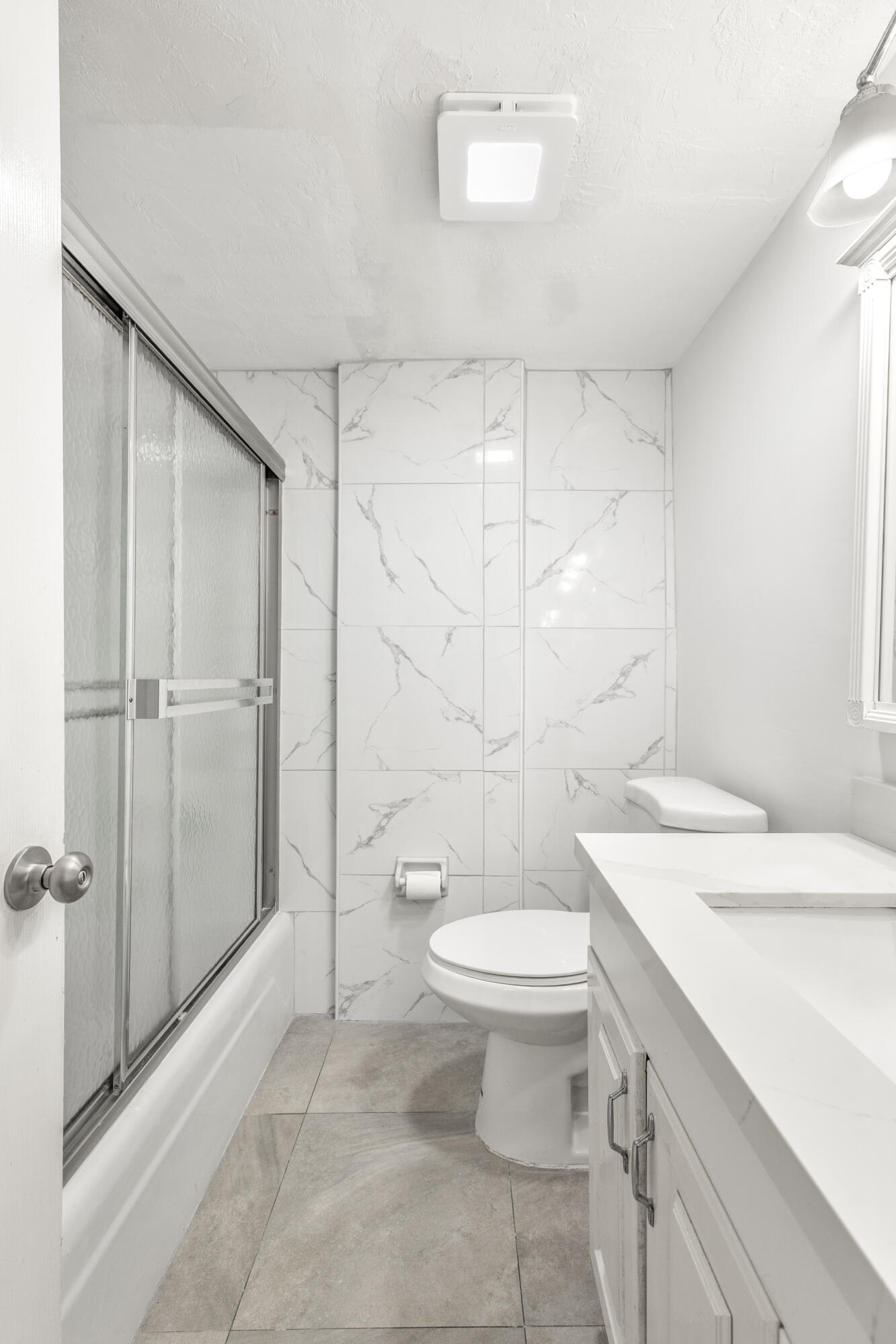 1021 Northeast 24th Avenue, Unit 12 Pompano Beach, FL 33062 - Photo 28 of 33 a bathroom with a sink a toilet and shower