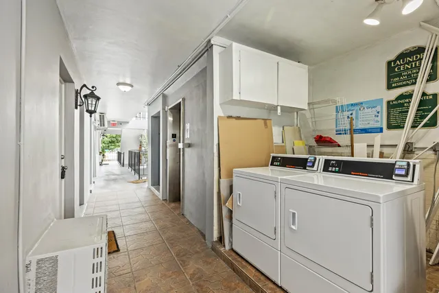 a view of a hallway with wooden shelves
