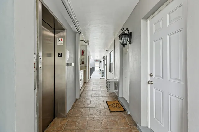 a view of a hallway with workspace and entryway